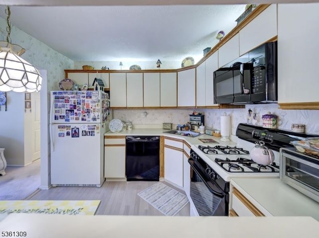 1605 Breckenridge Dr, Branchburg Twp, NJ 08876 - kitchen featuring black appliances, light countertops, wallpapered walls, light wood-style floors, and decorative light fixtures