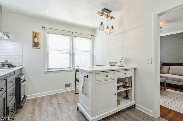 1 Hollywood Dr, Woodbridge Twp, NJ 07095 - kitchen featuring wall chimney range hood, wood finished floors, light countertops, wall oven, and pendant lighting
