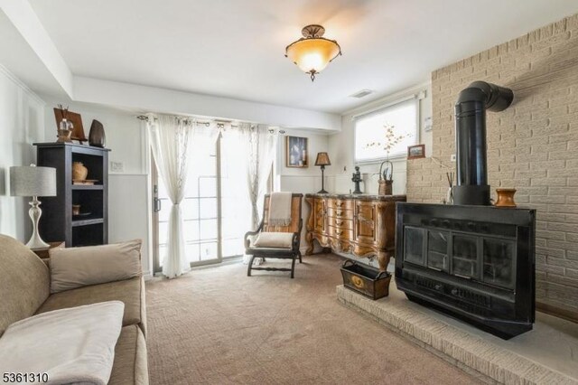 1 Hollywood Dr, Woodbridge Twp, NJ 07095 - carpeted living area featuring a wood stove and brick wall