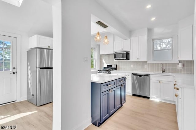 39 Johnson Rd, West Orange Twp, NJ 07052 - kitchen with stainless steel appliances, light wood-style flooring, white cabinets, light countertops, and a sink