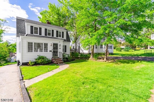 39 Johnson Rd, West Orange Twp, NJ 07052 - colonial inspired home with a chimney, a front lawn, and roof with shingles