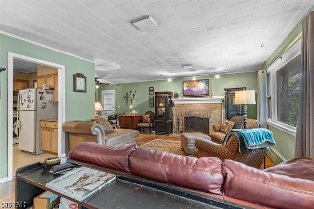 1337 State Route 57, Mansfield Twp, NJ 07865 - living room featuring healthy amount of natural light, a fireplace, a baseboard radiator, and ceiling fan