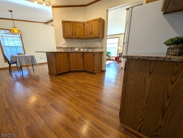 4 Stone Hill Ln, White Twp, NJ 07823 - kitchen with crown molding, dark wood-style flooring, brown cabinetry, pendant lighting, and tasteful backsplash