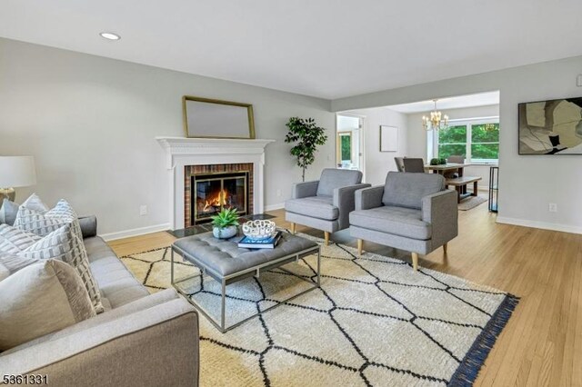 908 Willow Grove Rd, Westfield Town, NJ 07090 - living room with a chandelier, wood finished floors, baseboards, a brick fireplace, and recessed lighting