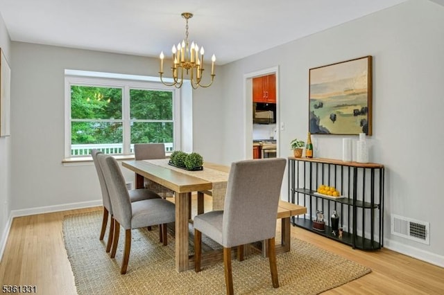 908 Willow Grove Rd, Westfield Town, NJ 07090 - dining room featuring a chandelier, light wood-type flooring, and baseboards