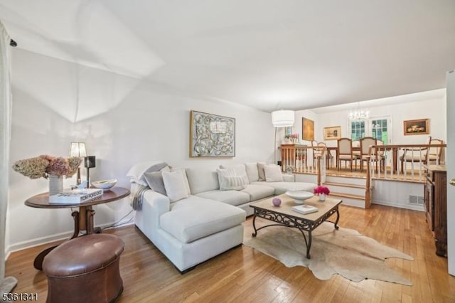 2 Skyline Dr, Morris Twp, NJ 07960 - living area featuring a chandelier, light wood finished floors, and baseboards