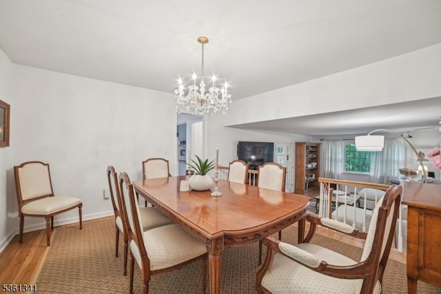 2 Skyline Dr, Morris Twp, NJ 07960 - dining space with light wood-style floors, a chandelier, and baseboards