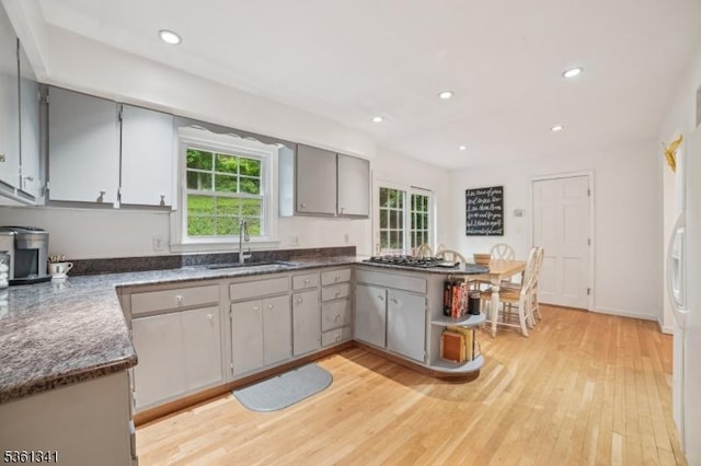 2 Skyline Dr, Morris Twp, NJ 07960 - kitchen featuring a sink, light wood-style flooring, gray cabinetry, a peninsula, and a wood stove