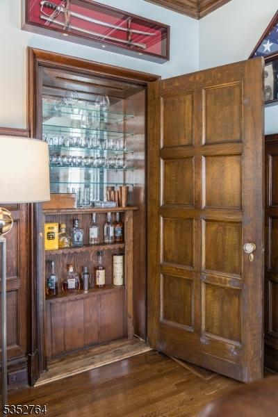 10 Rowan Rd, Summit City, NJ 07901 - bar featuring dark wood finished floors and ornamental molding