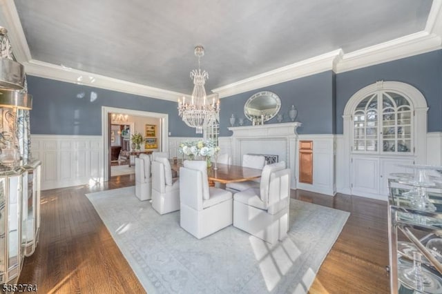10 Rowan Rd, Summit City, NJ 07901 - dining room with ornamental molding, a chandelier, a decorative wall, hardwood / wood-style floors, and wainscoting