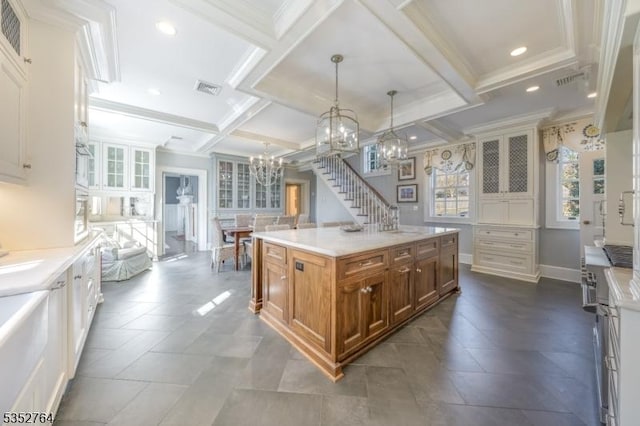 10 Rowan Rd, Summit City, NJ 07901 - kitchen featuring a chandelier, brown cabinets, coffered ceiling, glass insert cabinets, and beam ceiling