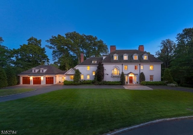 10 Rowan Rd, Summit City, NJ 07901 - view of front of home with a chimney, asphalt driveway, a front lawn, a garage, and stucco siding