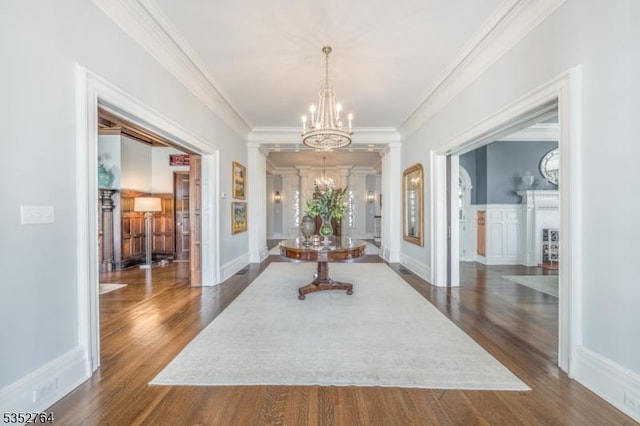 10 Rowan Rd, Summit City, NJ 07901 - hall featuring a chandelier, dark wood-style floors, crown molding, and decorative columns