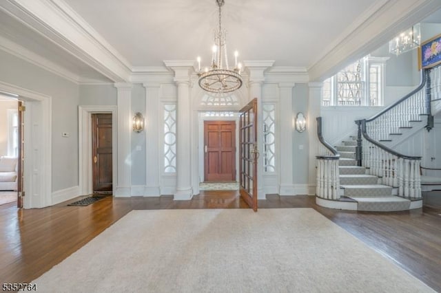 10 Rowan Rd, Summit City, NJ 07901 - foyer entrance with a chandelier, wood finished floors, ornamental molding, ornate columns, and stairs