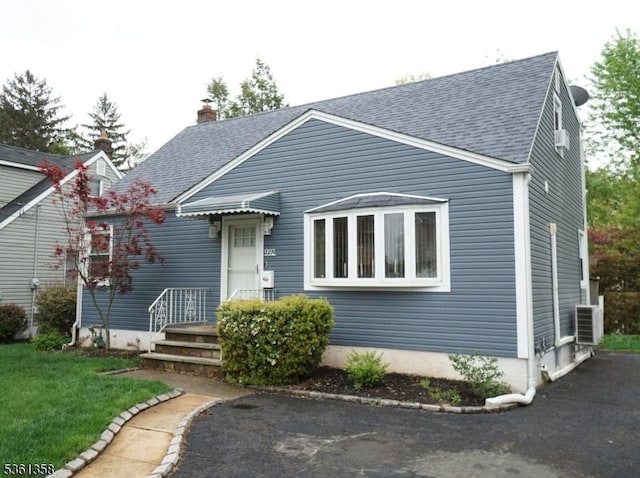 992 Milton Blvd, Rahway City, NJ 07065 - view of front facade with a shingled roof and a chimney