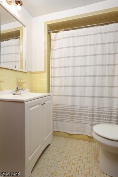 992 Milton Blvd, Rahway City, NJ 07065 - full bathroom with vanity, a shower with shower curtain, and tile patterned floors