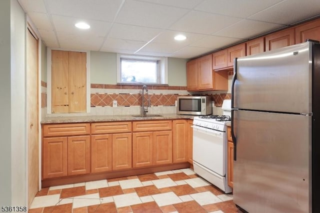 992 Milton Blvd, Rahway City, NJ 07065 - kitchen with stainless steel appliances, light stone countertops, a paneled ceiling, tasteful backsplash, and recessed lighting