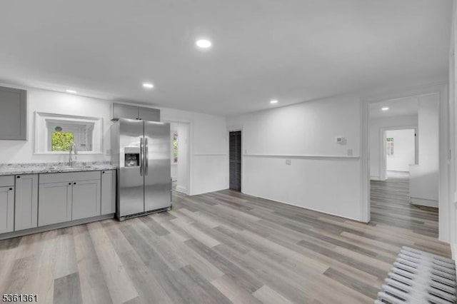 18 Ann St, Knowlton Twp, NJ 07832 - kitchen featuring stainless steel fridge with ice dispenser, gray cabinetry, light wood-style floors, a sink, and light stone countertops