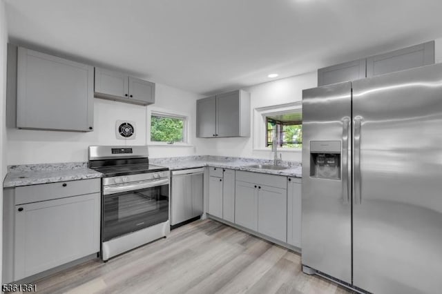 18 Ann St, Knowlton Twp, NJ 07832 - kitchen with appliances with stainless steel finishes, gray cabinetry, a sink, light wood-type flooring, and light stone countertops