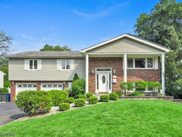 86 Belmont Ave, Cranford Twp, NJ 07016 - bi-level home featuring brick siding, driveway, a front lawn, and an attached garage