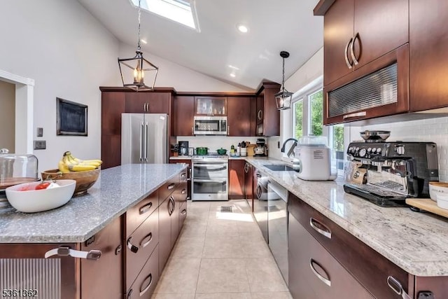 86 Belmont Ave, Cranford Twp, NJ 07016 - kitchen featuring appliances with stainless steel finishes, a sink, backsplash, hanging light fixtures, and light stone countertops