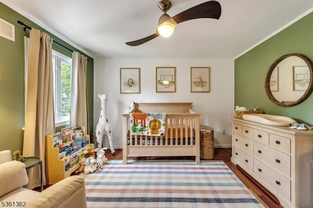 86 Belmont Ave, Cranford Twp, NJ 07016 - bedroom with wood finished floors, ceiling fan, baseboards, a nursery area, and ornamental molding