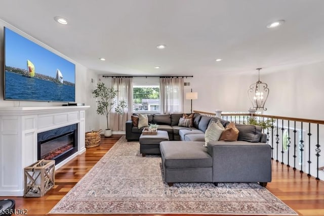 86 Belmont Ave, Cranford Twp, NJ 07016 - living room featuring a glass covered fireplace, wood finished floors, recessed lighting, and a chandelier