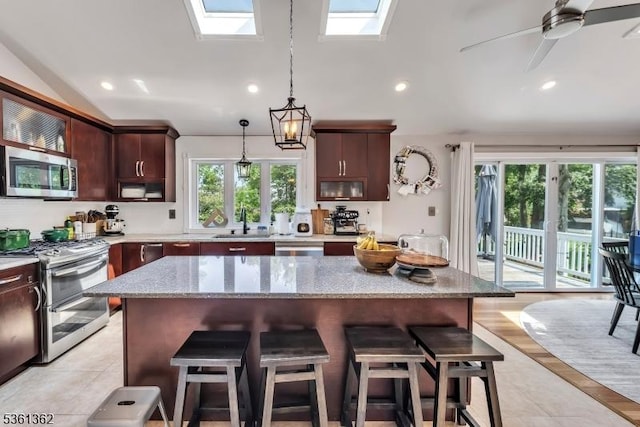 86 Belmont Ave, Cranford Twp, NJ 07016 - kitchen with appliances with stainless steel finishes, a skylight, a sink, lofted ceiling, and a kitchen breakfast bar