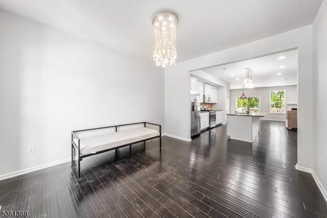 11 Woodland Way, Mount Arlington Boro, NJ 07856 - dining area featuring a chandelier, dark wood-style floors, and baseboards