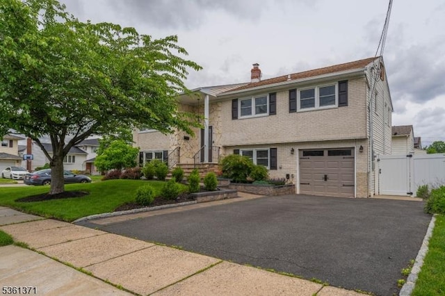2507 Jay Pl, Union Twp, NJ 07083 - view of front of home featuring a chimney, brick siding, an attached garage, and a gate