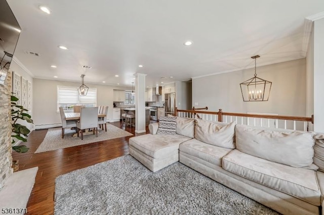 2507 Jay Pl, Union Twp, NJ 07083 - living area with a baseboard heating unit, wood finished floors, crown molding, a chandelier, and recessed lighting