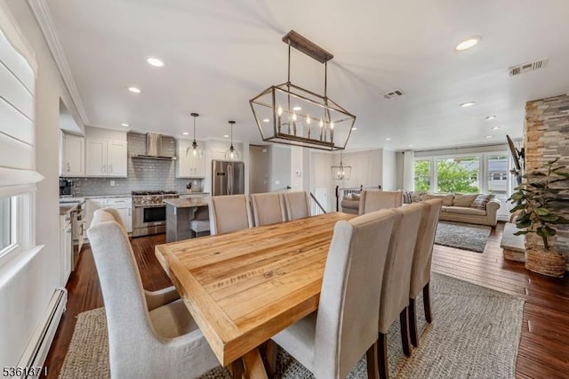 2507 Jay Pl, Union Twp, NJ 07083 - dining space with baseboard heating, dark wood-style flooring, crown molding, a chandelier, and recessed lighting