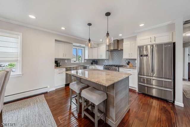 2507 Jay Pl, Union Twp, NJ 07083 - kitchen featuring stainless steel appliances, wall chimney range hood, a baseboard heating unit, white cabinets, and crown molding