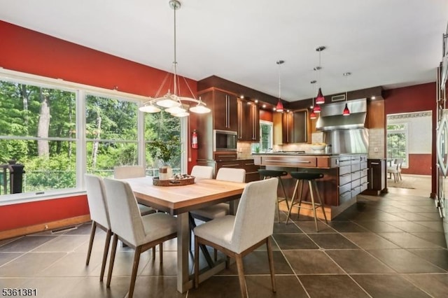 25 Castle Ct, Randolph Twp, NJ 07869 - dining room with dark tile patterned floors and a chandelier