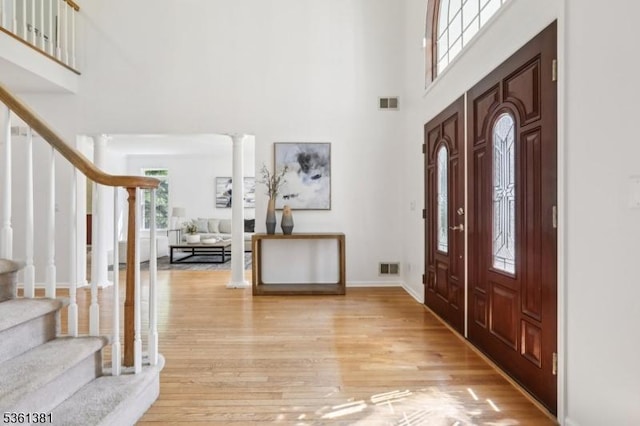 25 Castle Ct, Randolph Twp, NJ 07869 - foyer with a towering ceiling, stairway, light wood-style flooring, baseboards, and ornate columns