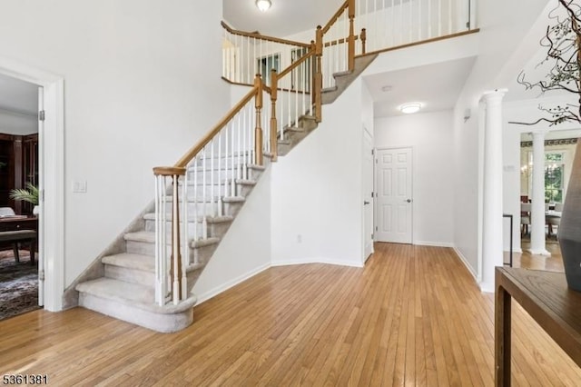 25 Castle Ct, Randolph Twp, NJ 07869 - foyer entrance featuring decorative columns, hardwood / wood-style floors, a high ceiling, stairs, and baseboards