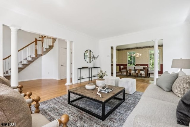 25 Castle Ct, Randolph Twp, NJ 07869 - living room featuring decorative columns, stairway, wood finished floors, a chandelier, and crown molding