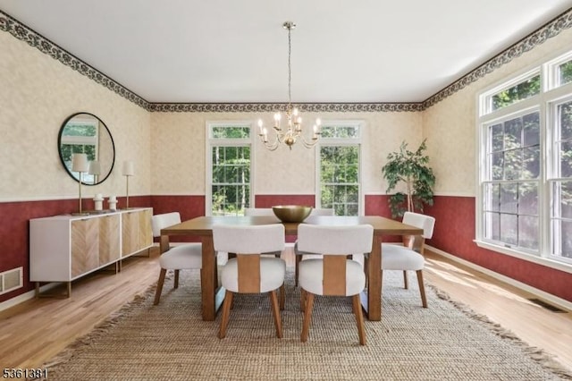25 Castle Ct, Randolph Twp, NJ 07869 - dining area featuring wood finished floors, wallpapered walls, a chandelier, a wainscoted wall, and baseboards
