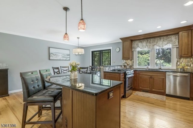 22 Messig Rd, Clinton Town, NJ 08809 - kitchen with stainless steel appliances, a sink, tasteful backsplash, light wood finished floors, and brown cabinetry