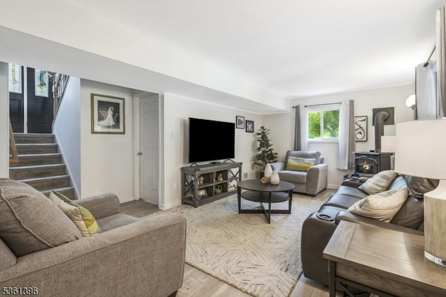 22 Messig Rd, Clinton Town, NJ 08809 - living room featuring a wood stove, stairs, baseboards, and light wood-type flooring