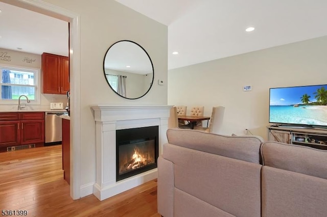 29 Black Oak Dr, Vernon Twp, NJ 07462 - living area with light wood finished floors, a glass covered fireplace, and recessed lighting