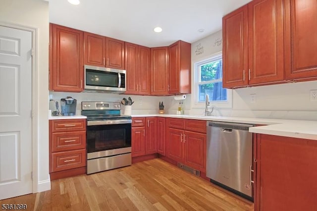 29 Black Oak Dr, Vernon Twp, NJ 07462 - kitchen with appliances with stainless steel finishes, a sink, light wood-type flooring, light countertops, and recessed lighting
