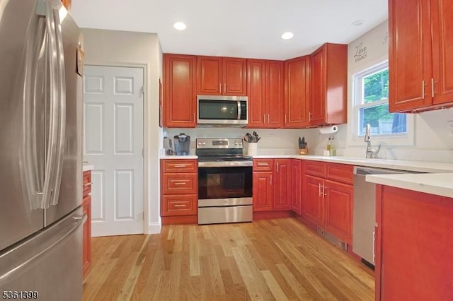29 Black Oak Dr, Vernon Twp, NJ 07462 - kitchen with stainless steel appliances, light countertops, light wood finished floors, recessed lighting, and a sink