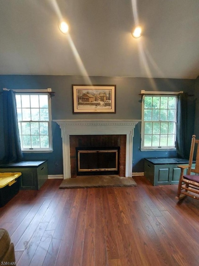 4 Babbitt Ct, Newton Town, NJ 07860 - living room featuring a fireplace with raised hearth, dark wood-style flooring, and baseboards