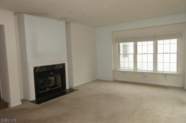7 Troon Dr, Fredon Twp, NJ 07860 - unfurnished living room featuring carpet, a premium fireplace, and baseboards