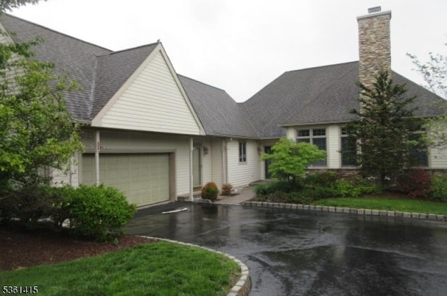 7 Troon Dr, Fredon Twp, NJ 07860 - traditional home featuring a garage, asphalt driveway, a chimney, and a shingled roof