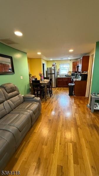 28 1st St, Elizabeth City, NJ 07206 - living room featuring light wood-type flooring and recessed lighting