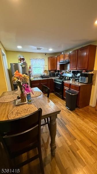 28 1st St, Elizabeth City, NJ 07206 - dining area with light wood-style flooring and recessed lighting