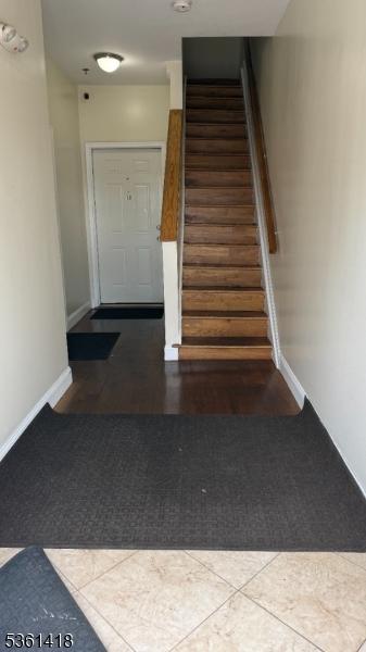 28 1st St, Elizabeth City, NJ 07206 - staircase with carpet flooring and baseboards