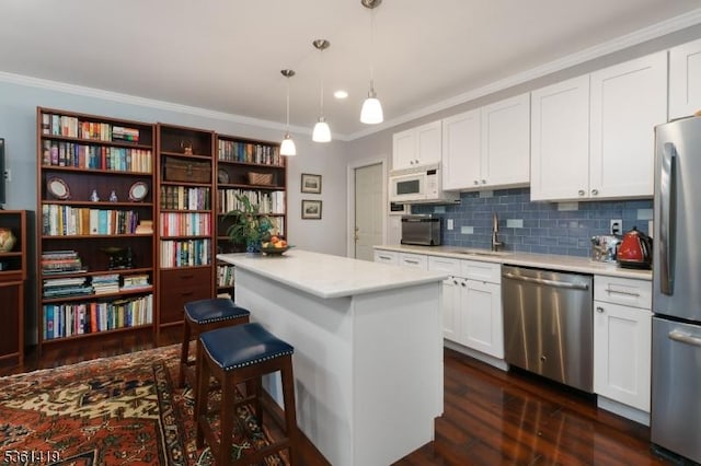 50 Skillman Rd, Montgomery Twp, NJ 08558 - kitchen featuring appliances with stainless steel finishes, ornamental molding, a sink, dark wood finished floors, and light countertops